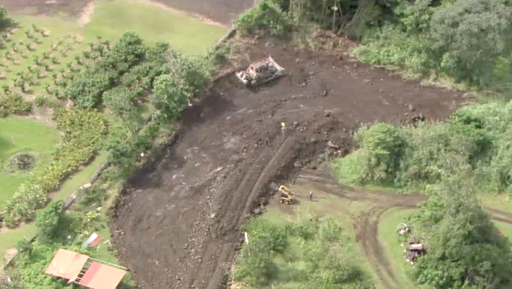 Image from overflight shows a Pahoa resident building aa 250 foot berm with a bulldozer in an attempt to save his home. Taken from video provided by Mick Kalber aboard Paradise Helicopters.